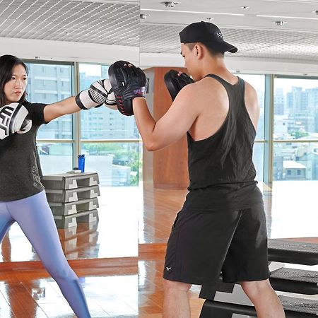 Windsor Hotel Тайджун Екстериор снимка A woman and a man training in a gym